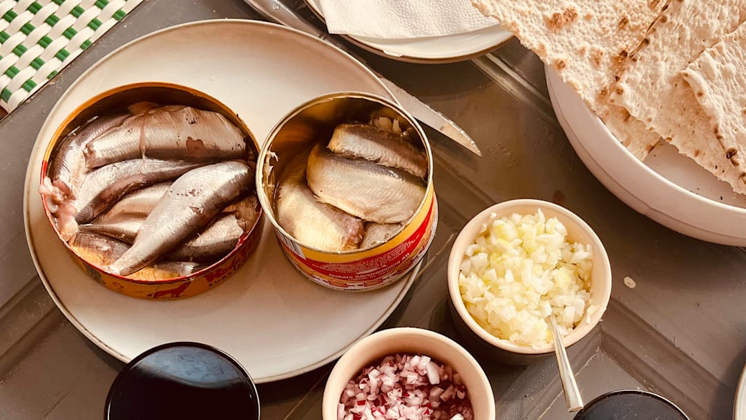 Traditional Swedish surströmming feast with sides and crispbread. Traditional Swedish surströmming feast with sides and crispbread.