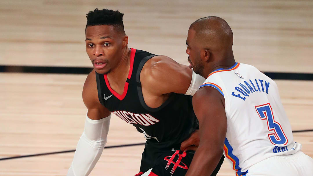 Sep 2, 2020; Lake Buena Vista, Florida, USA; Houston Rockets guard Russell Westbrook (0) dribbles the ball against Oklahoma City Thunder guard Chris Paul (3) during the second half of game seven of the first round of the 2020 NBA Playoffs at ESPN Wide World of Sports Complex. Mandatory Credit: Kim Klement-Imagn Images