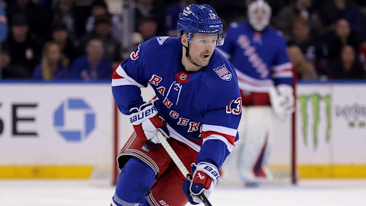 Mar 27, 2026; New York, New York, USA; New York Rangers left wing Alexis Lafreniere (13) brings the puck up ice against the Chicago Blackhawks during the second period at Madison Square Garden.