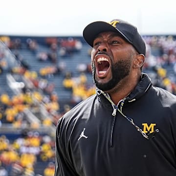 Sep 7, 2024; Ann Arbor, Michigan, USA; Michigan head coach Sherrone Moore cheers with the student section during warm ups at Michigan Stadium. Mandatory Credit: Junfu Han-USA TODAY Network via Imagn Images