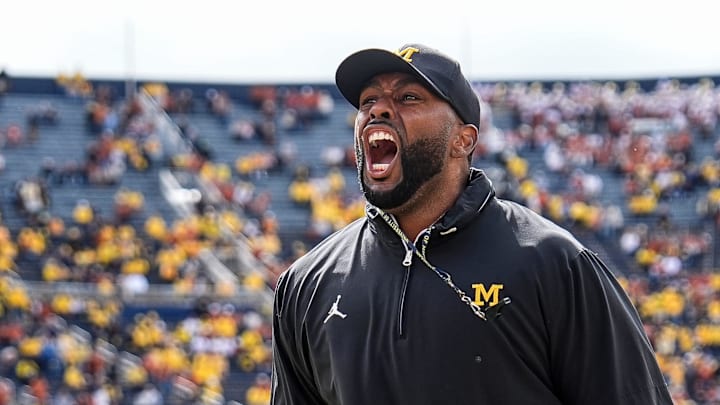 Sep 7, 2024; Ann Arbor, Michigan, USA; Michigan head coach Sherrone Moore cheers with the student section during warm ups at Michigan Stadium. Mandatory Credit: Junfu Han-USA TODAY Network via Imagn Images