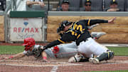 Pittsburgh Pirates catcher Henry Davis tags Cincinnati Reds first baseman Spencer Steer out at home plate attempting to score a run during the sixth inning at PNC Park. 