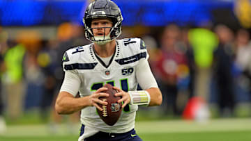 Nov 16, 2025; Inglewood, California, USA; Seattle Seahawks quarterback Sam Darnold (14) rolls out to pass during the first half against the Los Angeles Rams at SoFi Stadium. 