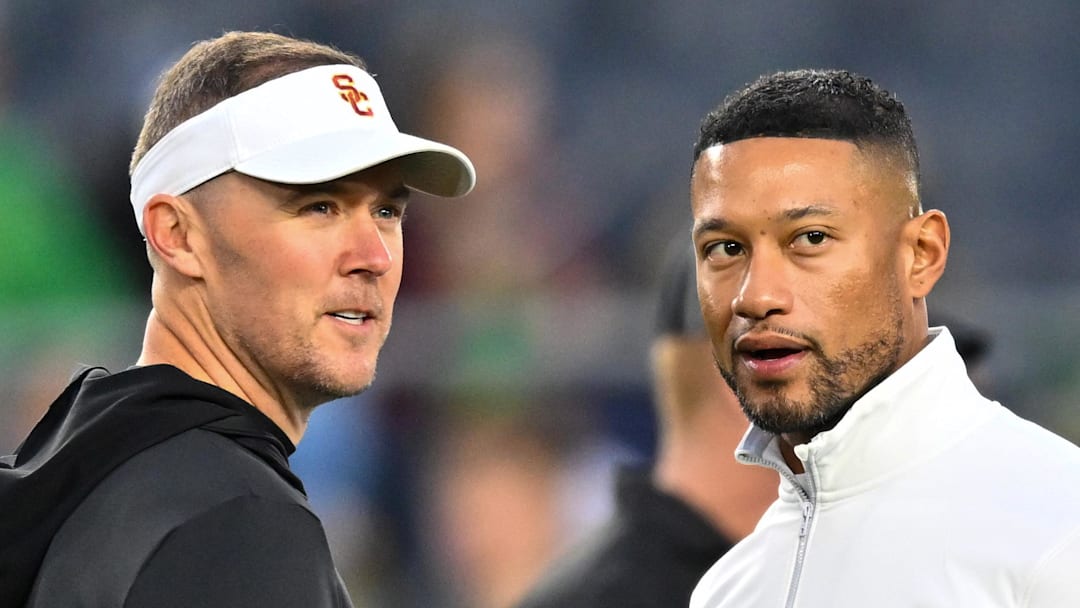Oct 14, 2023; South Bend, Indiana, USA; USC Trojans head coach Lincoln Riley and Notre Dame Fighting Irish head coach Marcus Freeman chat before the game at Notre Dame Stadium. Mandatory Credit: Matt Cashore-Imagn Images