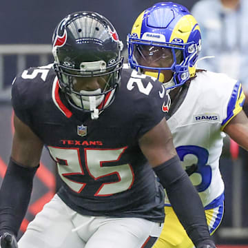 Aug 24, 2024; Houston, Texas, USA;  Houston Texans cornerback Desmond King II (25) fumbles against Los Angeles Rams cornerback Cam Lampkin (33) in the first quarter at NRG Stadium. Mandatory Credit: Thomas Shea-Imagn Images