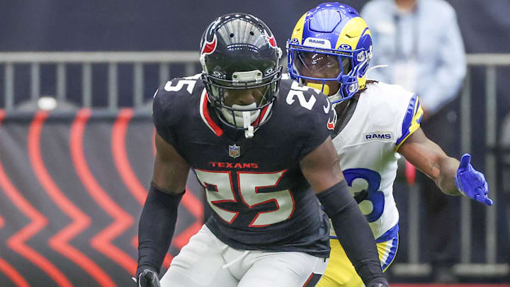 Aug 24, 2024; Houston, Texas, USA;  Houston Texans cornerback Desmond King II (25) fumbles against Los Angeles Rams cornerback Cam Lampkin (33) in the first quarter at NRG Stadium. Mandatory Credit: Thomas Shea-Imagn Images