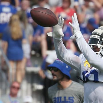 Bills wide receiver K.J. Hamler pulls in a pass across the middle during route drills.
