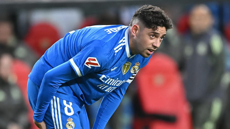 Federico Valverde clutching his hamstring.