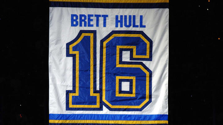 Dec 5, 2006; St. Louis, MO, USA;  Brett Hull and his father Bobby Hull hug in front of Brett's jersey as it starts to rise to the rafters before the Detroit Red Wings and the St. Louis Blues game at the Scottrade Center in St. Louis, MO. Mandatory Credit:Scott Rovak-Imagn Images Copyright © Scott Rovak