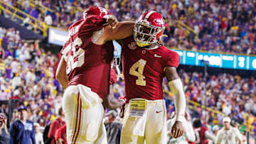 Nov 9, 2024; Baton Rouge, Louisiana, USA;  Alabama Crimson Tide quarterback Jalen Milroe (4) celebrates a touchdown with offensive lineman Geno VanDeMark (56) against the LSU Tigers during the second half at Tiger Stadium. Mandatory Credit: Stephen Lew-Imagn Images