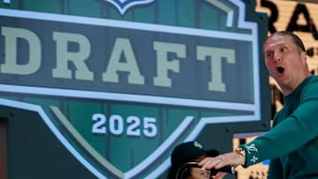 Former Green Bay Packers linebacker Clay Matthews rides a bicycle onto the Draft Theater stage before the first round of the 2025 NFL Draft 