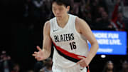 Oct 10, 2025; Portland, Oregon, USA;  Portland Trail Blazers center Yang Hansen  (16) reacts after making a three point shot against Sacramento Kings in the second half at Moda Center. Mandatory Credit: Jaime Valdez-Imagn Images