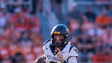 Oct 5, 2024; Stillwater, Oklahoma, USA; West Virginia Mountaineers quarterback Garrett Greene (6) runs the ball against the Oklahoma State Cowboys during the fourth quarter at Boone Pickens Stadium. Mandatory Credit: William Purnell-Imagn Images