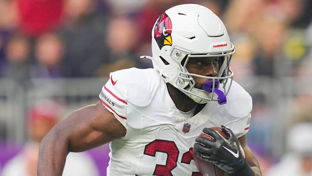 Dec 1, 2024; Minneapolis, Minnesota, USA; Arizona Cardinals running back Trey Benson (33) runs with the ball against the Minnesota Vikings in the first quarter at U.S. Bank Stadium. Mandatory Credit: Brad Rempel-Imagn Images