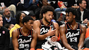 Mar 22, 2024; Detroit, Michigan, USA; Detroit Pistons guard Cade Cunningham (2) (center) talks with guard Jaden Ivey (23) (left) and  center James Wiseman (13) on the bench in the first quarter of their game against the Boston Celtics at Little Caesars Arena. Mandatory Credit: Lon Horwedel-Imagn Images