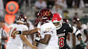 Savannah Christian's LaDamion Guyton pressures New Hampstead quarterback Rashawn Truell.