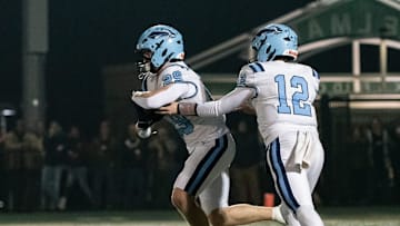 North Penn quarterback Matt Bucksar hands off to running back Matthew Pownall in the PIAA District One Class 6A championship football game against Pennridge, Friday, Nov. 21, 2025, at Helman Field in Perkasie. The Knights clinched the district title with a 21-14 win over the Rams.