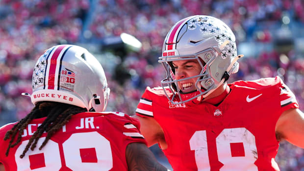 Ohio State Buckeyes quarterback Will Howard (18) celebrates with tight end Gee Scott Jr. (88)
