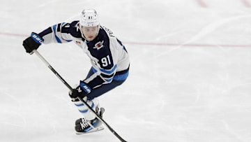Feb 6, 2024; Pittsburgh, Pennsylvania, USA;  Winnipeg Jets center Cole Perfetti (91) skates the puck against the Pittsburgh Penguins during the third period at PPG Paints Arena. The Penguins shutout the Jets 3-0. Mandatory Credit: Charles LeClaire-Imagn Images
