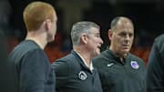 Boise State assistant coaches David Moats, left, and Tim Duryea, right, speak with head coach Leon Rice.