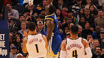 Mar 17, 2025; San Francisco, California, USA; Golden State Warriors forward Draymond Green (23) scores a layup above Denver Nuggets forward Michael Porter Jr. (1), and guard Russell Westbrook (4) during the fourth quarter at Chase Center. Mandatory Credit: Kelley L Cox-Imagn Images