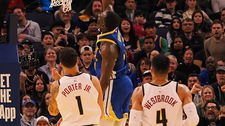 Mar 17, 2025; San Francisco, California, USA; Golden State Warriors forward Draymond Green (23) scores a layup above Denver Nuggets forward Michael Porter Jr. (1), and guard Russell Westbrook (4) during the fourth quarter at Chase Center. Mandatory Credit: Kelley L Cox-Imagn Images
