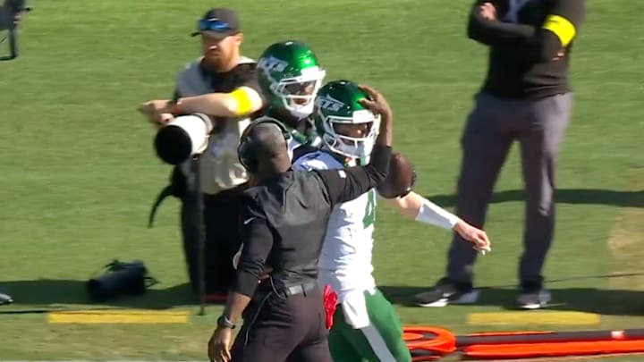 Jets receiver AD Mitchell chased down Brady Cook to give him his first NFL touchdown football. Jets receiver AD Mitchell chased down Brady Cook to give him his first NFL touchdown football.