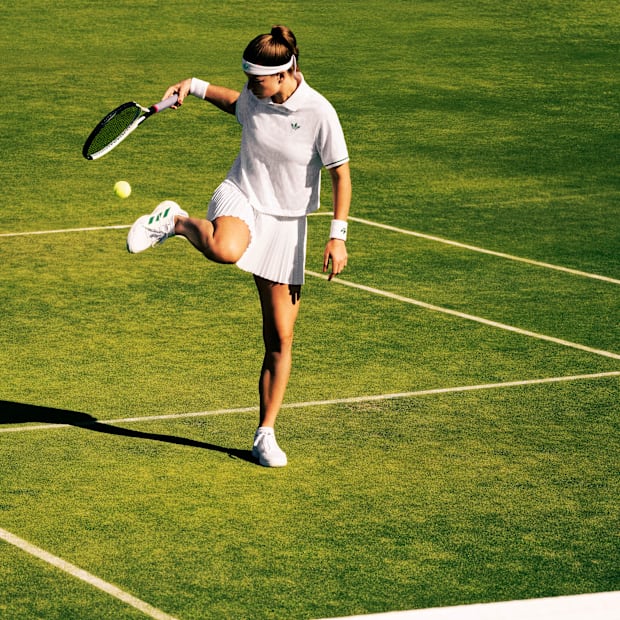 Karolína Muchová models adidas apparel on a grass tennis court.