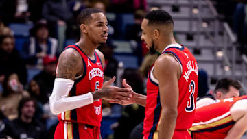 Jan 20, 2025; New Orleans, Louisiana, USA;  New Orleans Pelicans guard CJ McCollum (3) and guard Dejounte Murray (5) slap hands after a play against the Utah Jazz during the second half at Smoothie King Center. Mandatory Credit: Stephen Lew-Imagn Images