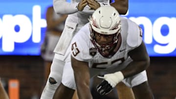 Sep 28, 2024; Dallas, Texas, USA; Florida State Seminoles quarterback DJ Uiagalelei (4) and offensive lineman Maurice Smith (53) in action during the game between the Southern Methodist Mustangs and the Florida State Seminoles at Gerald J. Ford Stadium. Mandatory Credit: Jerome Miron-Imagn Images