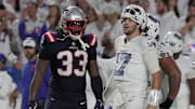 Buffalo Bills quarterback Josh Allen reacts to a play during second half action at at Highmark Stadium in Orchard Park on Oct. 5, 2025. Besides him, New England Patriots linebacker Anfernee Jennings watches.