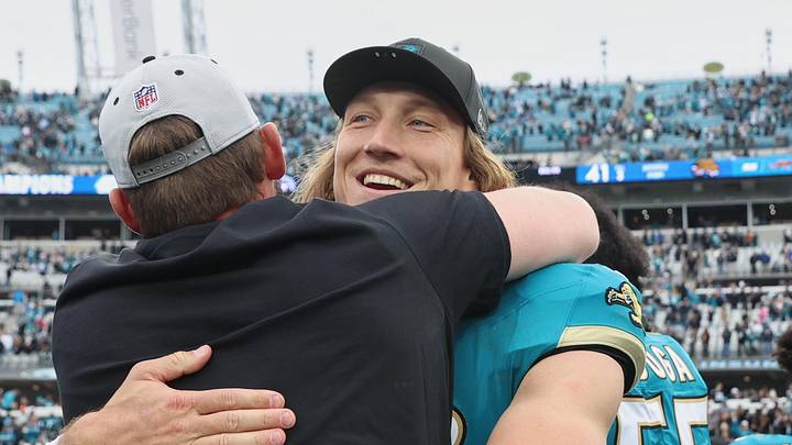 Jan 4, 2026; Jacksonville, Florida, USA; Jacksonville Jaguars quarterback Trevor Lawrence (16) celebrates with head coach Liam Coen (obscured) after the game against the Tennessee Titans at EverBank Stadium. 