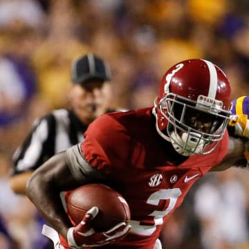 Alabama wide receiver Calvin Ridley (3) stiff arms LSU defensive back Dwayne Thomas (13) as he runs up the sidelines during the first half of Alabama's game with LSU in Tiger Stadium Saturday, November 5, 2016.