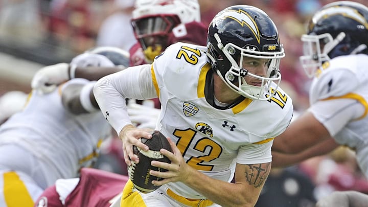 Sep 20, 2025; Tallahassee, Florida, USA; Kent State Golden Flashes quarterback Dru DeShields (12) scrambles out of the pocket during the first half against the Florida State Seminoles at Doak S. Campbell Stadium. Mandatory Credit: Melina Myers-Imagn Images
