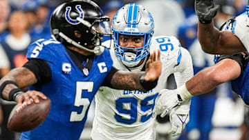 Detroit Lions defensive end Za'Darius Smith (99) pressures Indianapolis Colts quarterback Anthony Richardson (5) during the second half at Lucas Oil Stadium in Indianapolis, Ind. on Sunday, Nov. 24, 2024.