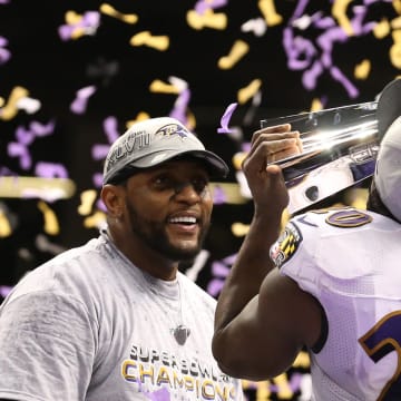 Feb 3, 2013; New Orleans, LA, USA; Baltimore Ravens safety Ed Reed (20) kisses the Vince Lombardi Trophy as linebacker Ray Lewis (left) smiles after defeating the San Francisco 49ers 34-31 in Super Bowl XLVII at the Mercedes-Benz Superdome.Mandatory Credit: Matthew Emmons-USA TODAY Sports