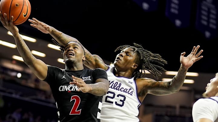 Dec 30, 2024; Manhattan, Kansas, USA; Cincinnati Bearcats guard Jizzle James (2) shoots against Kansas State Wildcats guard Macaleab Rich (23) during the first half at Bramlage Coliseum. Mandatory Credit: Jay Biggerstaff-Imagn Images