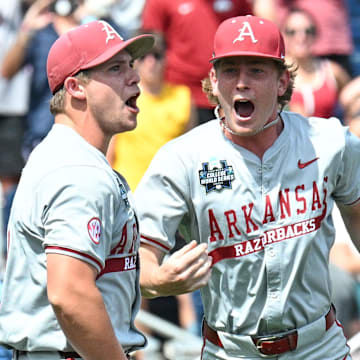 Arkansas Razorbacks starting pitcher Gage Wood celebrates with infielder Gabe Fraser.