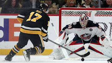 Jan 7, 2025; Pittsburgh, Pennsylvania, USA; Columbus Blue Jackets goaltender Elvis Merzlikins (90) defends the net against Pittsburgh Penguins right wing Bryan Rust (17) in overtime at PPG Paints Arena. Mandatory Credit: Charles LeClaire-Imagn Images