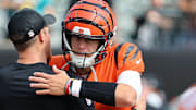 Sep 14, 2025; Cincinnati, Ohio, USA;  Cincinnati Bengals quarterback Joe Burrow (9) greets a coach before the game against the Jacksonville Jaguars at Paycor Stadium. Mandatory Credit: Joseph Maiorana-Imagn Images