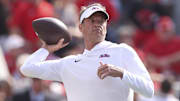 Oct 18, 2025; Athens, Georgia, USA; Mississippi Rebels head coach Lane Kiffin throws the ball prior to the game against the Georgia Bulldogs at Sanford Stadium. Mandatory Credit: Brett Davis-Imagn Images