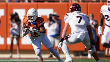 Sep 28, 2024; Austin, Texas, USA;  Texas Longhorns running back Jaydon Blue (23) runs the ball in front of Mississippi State Bulldogs linebacker Stone Blanton (7) in the first half at Darrell K Royal-Texas Memorial Stadium. Mandatory Credit: Daniel Dunn-Imagn Images