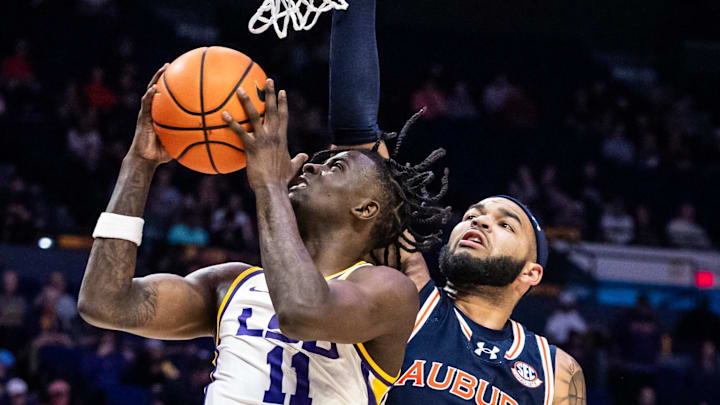 Jan 29, 2025; Baton Rouge, Louisiana, USA;  LSU Tigers forward Corey Chest (11) drives to the basket against Auburn Tigers forward Johni Broome (4) during the first half at Pete Maravich Assembly Center. Mandatory Credit: Stephen Lew-Imagn Images
