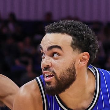 Orlando Magic guard Tyus Jones drives to the basket against Atlanta Hawks guard Trae Young.