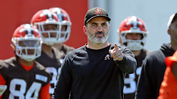 Cleveland Browns coach Kevin Stefanski watches quarterback Shedeur Sanders (12) participate in drills during day two of NFL rookie minicamp at the Cleveland Browns training facility May 10, 2025, in Berea, Ohio.