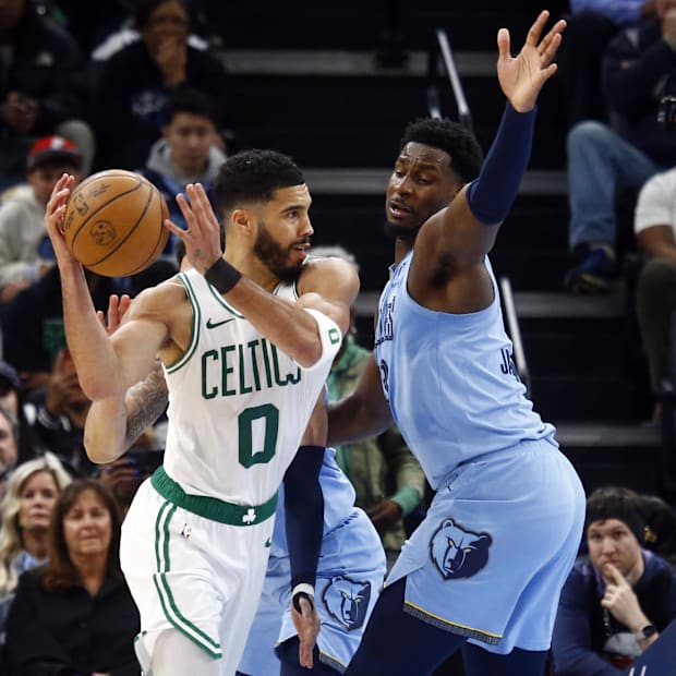 Boston Celtics forward Jayson Tatum (0) passes the ball as Memphis Grizzlies forward Jaren Jackson Jr. 