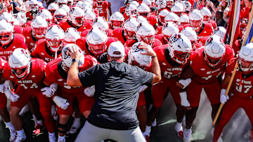 Oct 4, 2025; Raleigh, North Carolina, USA;  NC State Wolfpack head coach Dave Doeren with his team prepare to run out prior to the first half of the game against Campbell Fighting Camels at Carter-Finley Stadium. Mandatory Credit: Jaylynn Nash-Imagn Images