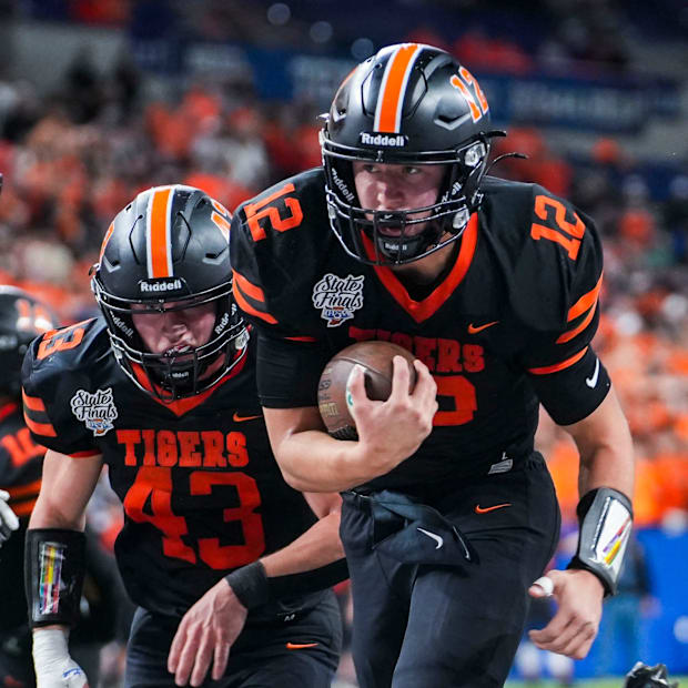 Warsaw Community Tigers Drew Sullivan (12) finds the end zone during last years 5A State Championship matchup.
