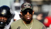 Nov 11, 2023; Boulder, Colorado, USA; Colorado Buffaloes head coach Deion Sanders runs on to the field before the first half against the Arizona Wildcats at Folsom Field. Mandatory Credit: Ron Chenoy-Imagn Images