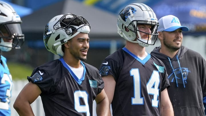 Jul 24, 2024; Charlotte, NC, USA;  Carolina Panthers quarterback Bryce Young (9) and quarterback Andy Dalton (14) watch practice at Carolina Panthers Practice Fields. Mandatory Credit: Jim Dedmon-USA TODAY Sports